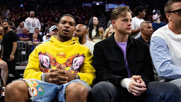 Feb 25, 2024; Phoenix, Arizona, USA; Cincinnati Bengals players Ja'Marr Chase (left) and Joe Burrow sit court side of the Phoenix Suns game against the Los Angeles Lakers at Footprint Center. Mandatory Credit: Mark J. Rebilas-USA TODAY Sports