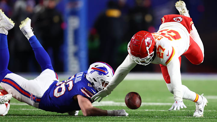 Jan 21, 2024; Orchard Park, New York, USA; Buffalo Bills tight end Dalton Kincaid (86) and Kansas City Chiefs wide receiver Nikko Remigio (27) attempt to revoker a fumble on special teams during the second half for the 2024 AFC divisional round game at Highmark Stadium. Mandatory Credit: Mark J. Rebilas-Imagn Images