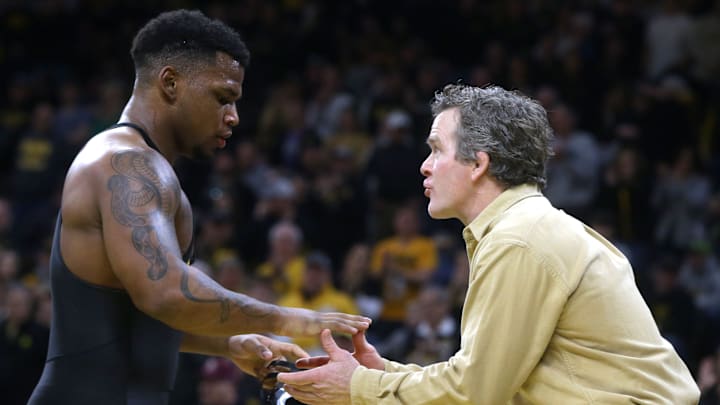 Iowa's Gabe Arnold talks to Associate Head Coach Terry Brands as he comes off the mat against Wisconsin Sunday, Feb. 18, 2024 at Carver-Hawkeye Arena in Iowa City, Iowa.