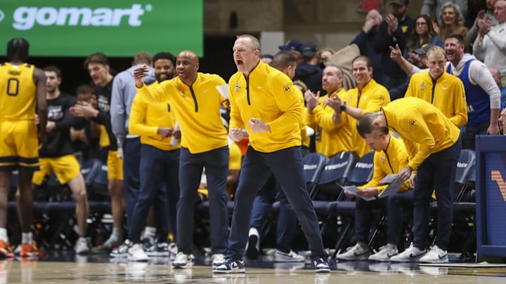 Feb 19, 2025; Morgantown, West Virginia, USA; West Virginia Mountaineers head coach Darian DeVries yells from the bench during the second half against the Cincinnati Bearcats at WVU Coliseum. Mandatory Credit: Ben Queen-Imagn Images Feb 19, 2025; Morgantown, West Virginia, USA; West Virginia Mountaineers head coach Darian DeVries yells from the bench during the second half against the Cincinnati Bearcats at WVU Coliseum. Mandatory Credit: Ben Queen-Imagn Images