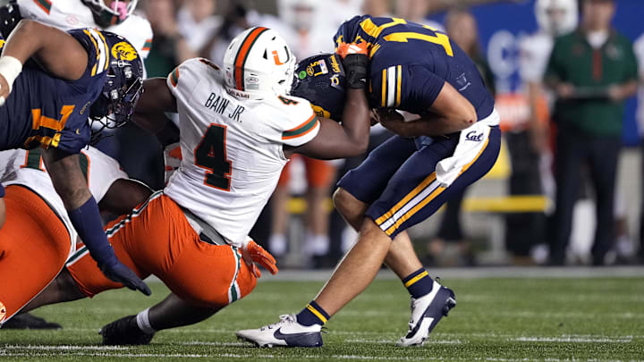 Oct 5, 2024; Berkeley, California, USA; Miami Hurricanes defensive lineman Rueben Bain Jr. (4) sacks California Golden Bears quarterback Fernando Mendoza (right) during the fourth quarter at California Memorial Stadium. Mandatory Credit: Darren Yamashita-Imagn Images