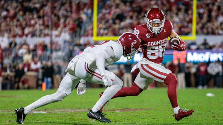 Nov 23, 2024; Norman, Oklahoma, USA; Oklahoma Sooners wide receiver Jacob Jordan (88) runs the ball around Alabama Crimson Tide defensive back Zabien Brown (2) during the second quarter at Gaylord Family-Oklahoma Memorial Stadium