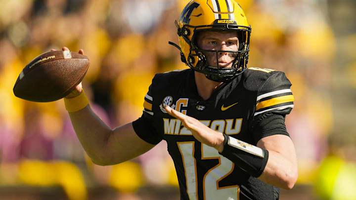Oct 19, 2024; Columbia, Missouri, USA; Missouri Tigers quarterback Brady Cook (12) throws a pass during the second half against the Auburn Tigers at Faurot Field at Memorial Stadium. Mandatory Credit: Jay Biggerstaff-Imagn Images