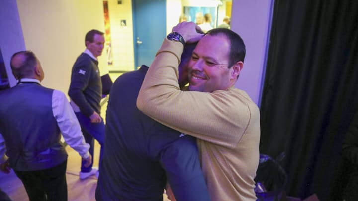 Jan 13, 2024; Morgantown, West Virginia, USA; West Virginia Mountaineers head coach Josh Eilert celebrates with West Virginia Mountaineers Athletic Director Wren Baker after defeating the Texas Longhorns at WVU Coliseum. Mandatory Credit: Ben Queen-Imagn Images
