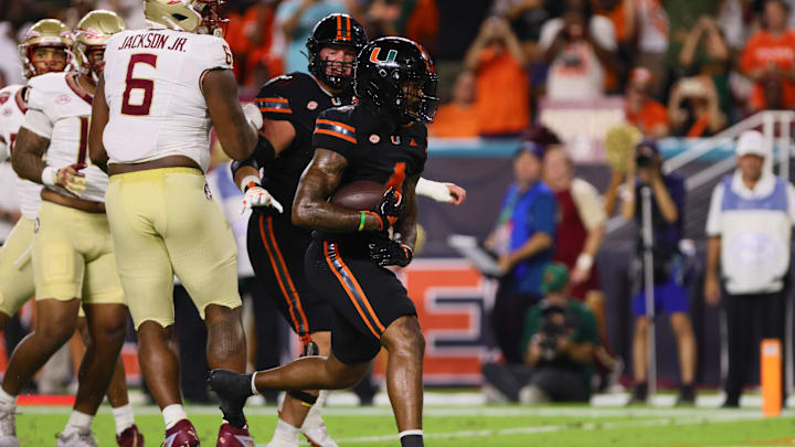 Oct 26, 2024; Miami Gardens, Florida, USA; Miami Hurricanes running back Mark Fletcher Jr. (4) runs with the football for a touchdown against the Florida State Seminoles during the first quarter at Hard Rock Stadium. Mandatory Credit: Sam Navarro-Imagn Images Oct 26, 2024; Miami Gardens, Florida, USA; Miami Hurricanes running back Mark Fletcher Jr. (4) runs with the football for a touchdown against the Florida State Seminoles during the first quarter at Hard Rock Stadium. Mandatory Credit: Sam Navarro-Imagn Images