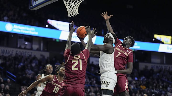 Feb 12, 2025; Winston-Salem, North Carolina, USA; Wake Forest Demon Deacons forward Omaha Biliew (0) loses the ball at the rim against Florida State Seminoles forward Alier Maluk (21) during the first half at Lawrence Joel Veterans Memorial Coliseum. Mandatory Credit: Jim Dedmon-Imagn Images