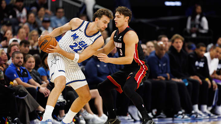 Oct 12, 2025; Orlando, Florida, USA; Miami Heat guard Pelle Larsson (9) defends Orlando Magic forward Franz Wagner (22) during the first half at Kia Center. Mandatory Credit: Matt Pendleton-Imagn Images