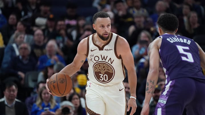 Apr 7, 2026; San Francisco, California, USA;  Golden State Warriors guard Stephen Curry (30) dribbles upcourt while defended by Sacramento Kings guard Nique Clifford (5) in the fourth quarter at Chase Center.