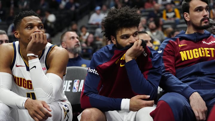 Mar 12, 2025; Denver, Colorado, USA; Denver Nuggets guard Russell Westbrook (4), guard Jamal Murray (27) and forward Dario Saric (9) on the bench in the fourth quarter against the Minnesota Timberwolves at Ball Arena. Mandatory Credit: Ron Chenoy-Imagn Images