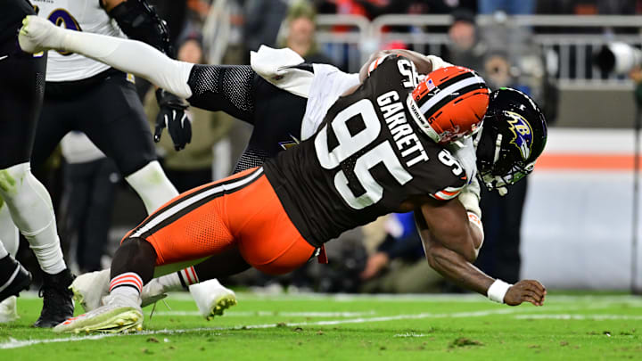 Nov 16, 2025; Cleveland, Ohio, USA; Cleveland Browns defensive end Myles Garrett (95) sacks Baltimore Ravens quarterback Lamar Jackson (8) during the second quarter at Huntington Bank Field. Mandatory Credit: Ken Blaze-Imagn Images