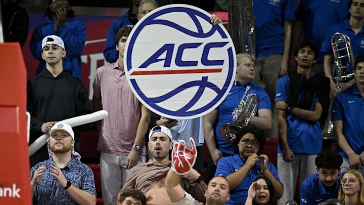 Feb 17, 2026; Dallas, Texas, USA; A fan holds up an ACC logo banner during the second half of the game between the SMU Mustangs and the Louisville Cardinals at Moody Coliseum. Mandatory Credit: Jerome Miron-Imagn Images