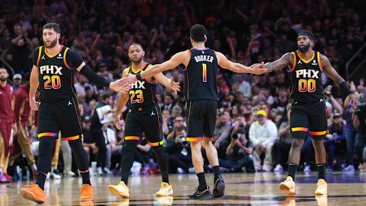 Apr 3, 2024; Phoenix, Arizona, USA; Phoenix Suns guard Devin Booker (1) slaps hands with Phoenix Suns center Jusuf Nurkic (20) and Phoenix Suns guard Eric Gordon (23) and Phoenix Suns forward Royce O'Neale (00) during the first half of the game against the Cleveland Cavaliers at Footprint Center. Mandatory Credit: Joe Camporeale-USA TODAY Sports