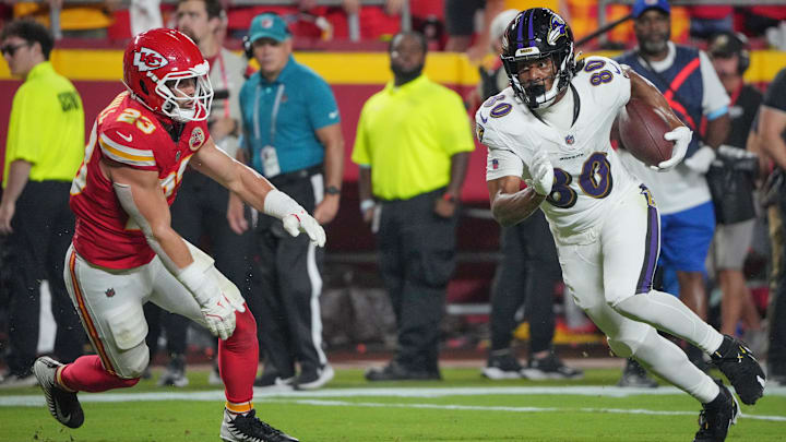 Sep 5, 2024; Kansas City, Missouri, USA; Baltimore Ravens tight end Isaiah Likely (80) runs the ball as Kansas City Chiefs linebacker Drue Tranquill (23) defends during the first half at GEHA Field at Arrowhead Stadium. Mandatory Credit: Denny Medley-Imagn Images
