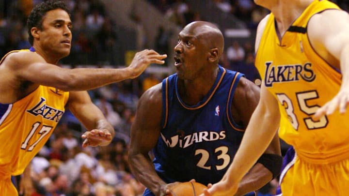 Mar 28, 2003; Los Angeles, CA, USA; FILE PHOTO; Washington Wizards guard Michael Jordan (23) drives to the basket between Los Angeles Lakers forward Rick Fox (44) and Mark Madsen (35) during the third quarter of the Wizards  108 - 94 loss to the Lakers at Staples Center. Jordan scored 23 points in the game. Mandatory Credit: Robert Hanashiro-Imagn Images