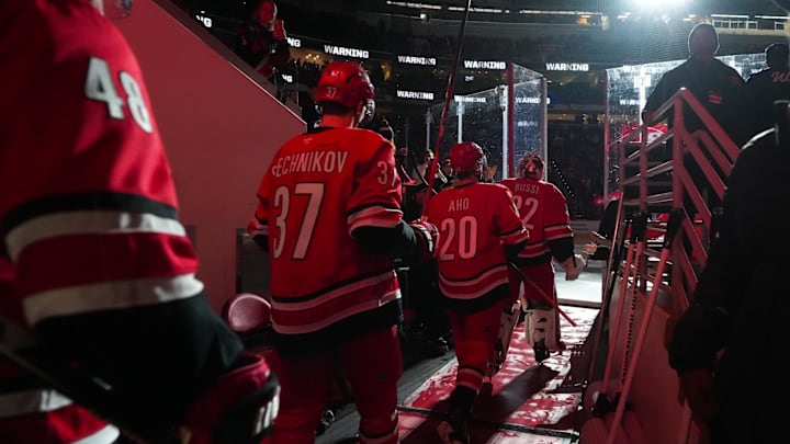 Dec 14, 2025; Raleigh, North Carolina, USA;  Carolina Hurricanes goaltender Brandon Bussi (32), center Sebastian Aho (20) and right wing Andrei Svechnikov (37) walk out of the locker room before the game against the Philadelphia Flyers at Lenovo Center. Mandatory Credit: James Guillory-Imagn Images