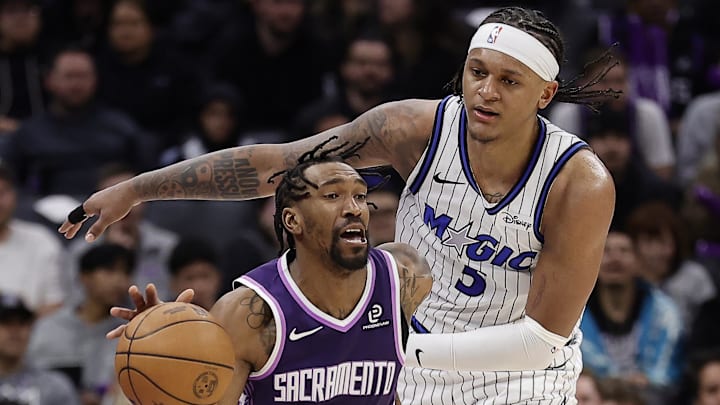 Feb 19, 2026; Sacramento, California, USA; Orlando Magic forward Paolo Banchero (5) fouls Sacramento Kings guard Malik Monk (0) during the third quarter at Golden 1 Center. Mandatory Credit: Kelley L Cox-Imagn Images Feb 19, 2026; Sacramento, California, USA; Orlando Magic forward Paolo Banchero (5) fouls Sacramento Kings guard Malik Monk (0) during the third quarter at Golden 1 Center. Mandatory Credit: Kelley L Cox-Imagn Images