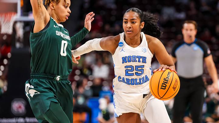 Mar 22, 2024; Columbia, SC, USA; North Carolina Tar Heels guard Deja Kelly (25) drives around Michigan State Spartans guard DeeDee Hagemann (0) in the second half at Colonial Life Arena. Mandatory Credit: Jeff Blake-USA TODAY Sports