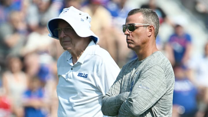 Jul 24, 2024; Rochester, NY, USA; Buffalo Bills owner Terry Pegula (left) and general manager Brandon Beane watch a training camp session at St. John Fisher University.