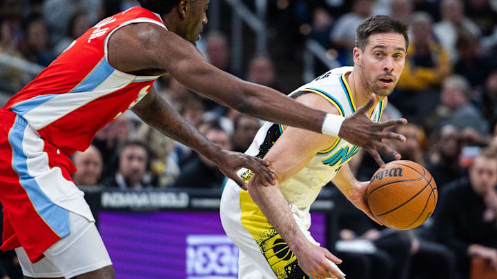 Feb 20, 2025; Indianapolis, Indiana, USA; Indiana Pacers guard T.J. McConnell (9) dribbles the ball while Memphis Grizzlies guard Vince Williams Jr. (5) defends in the second half at Gainbridge Fieldhouse. Mandatory Credit: Trevor Ruszkowski-Imagn Images