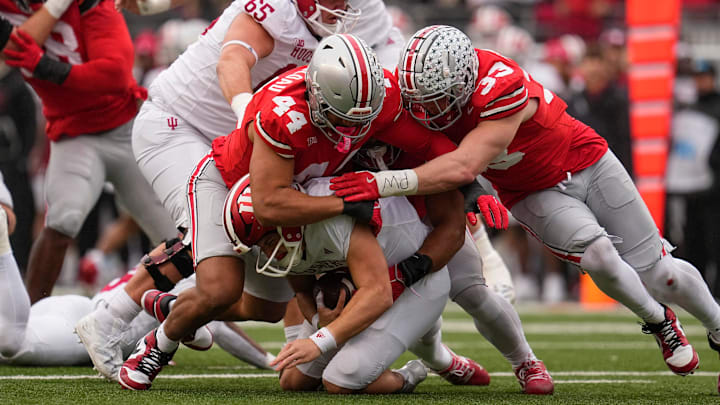 Ohio State Buckeyes defensive end JT Tuimoloau (44) and defensive end Jack Sawyer (33) sack Indiana Hoosiers quarterback Kurtis Rourke (9) during the first half of the NCAA football game at Ohio Stadium in Columbus on Saturday, Nov. 23, 2024.
