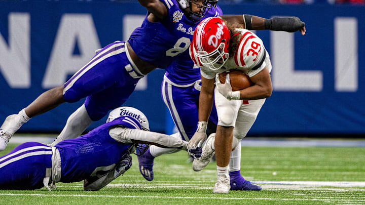 Ben Davis High School senior Nylan Brown (8) flies through the air to tackle Crown Point High School sophomore Trevor Gibbs (39) during the second half of an IHSAA Class 6A State Championship football game, Saturday, Nov. 25, 2023, at Lucas Oil Stadium, in Indianapolis. Ben Davis High School won, 38-10.