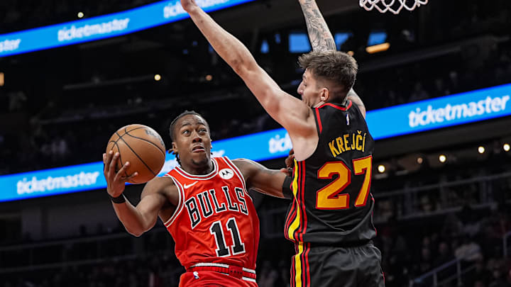 Dec 21, 2025; Atlanta, Georgia, USA; Chicago Bulls guard Ayo Dosunmu (11) tries to get to the basket against Atlanta Hawks guard Vit Krejci (27) during the second half at State Farm Arena. Mandatory Credit: Dale Zanine-Imagn Images