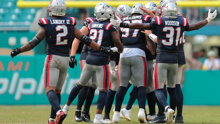 Sep 14, 2025; Miami Gardens, Florida, USA; New England Patriots defensive end Milton Williams (97) celebrates with teammates after sacking Miami Dolphins quarterback Tua Tagovailoa (1) during the fourth quarter at Hard Rock Stadium. Mandatory Credit: Sam Navarro-Imagn Images
