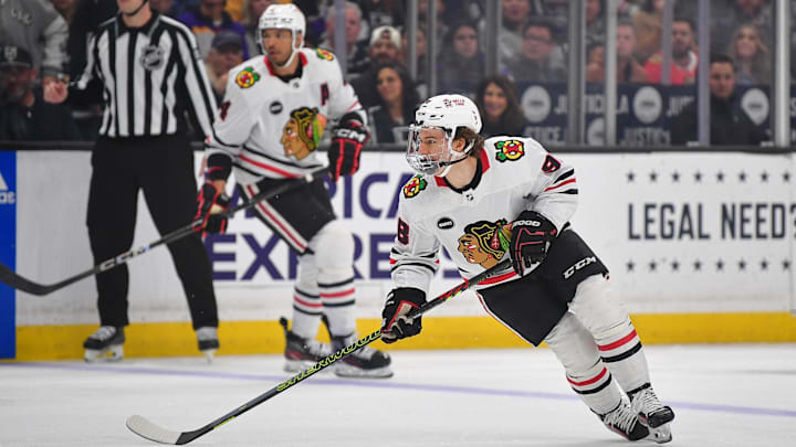 Apr 18, 2024; Los Angeles, California, USA; Chicago Blackhawks center Connor Bedard (98) controls the puck against the Los Angeles Kings during the first period at Crypto.com Arena. Mandatory Credit: Gary A. Vasquez-Imagn Images