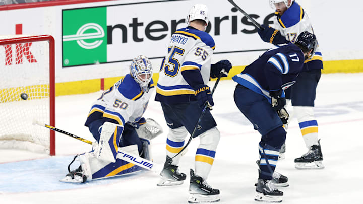 May 4, 2025; Winnipeg, Manitoba, CAN; Winnipeg Jets center Adam Lowry (17) scores a goal against St. Louis Blues goaltender Jordan Binnington (50) in the second overtime of game seven of the first round of the 2025 Stanley Cup Playoffs at Canada Life Centre. Mandatory Credit: James Carey Lauder-Imagn Images