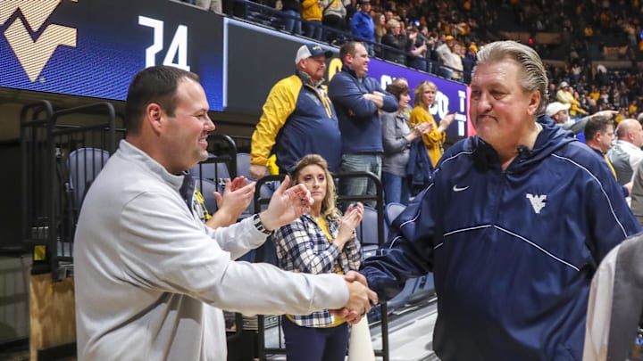 Jan 18, 2023; Morgantown, West Virginia, USA; West Virginia Mountaineers head coach Bob Huggins celebrates with West Virginia University Athletic Director Wren Baker after defeating the TCU Horned Frogs at WVU Coliseum. Mandatory Credit: Ben Queen-Imagn Images