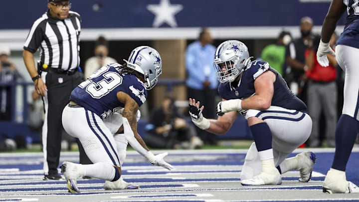 Dallas Cowboys running back Rico Dowdle celebrates with center Brock Hoffman after scoring a touchdown during the second half against the Washington Commanders.