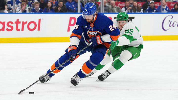 Mar 17, 2026; Toronto, Ontario, CAN; Toronto Maple Leafs right wing Easton Cowan (53) battles for the puck with New York Islanders defenseman Scott Mayfield (24) during the first period at Scotiabank Arena. Mandatory Credit: Nick Turchiaro-Imagn Images