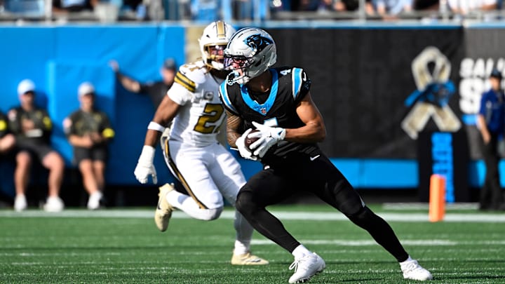 Nov 9, 2025; Charlotte, North Carolina, USA; Carolina Panthers wide receiver Tetairoa McMillan (4) with the ball as New Orleans Saints safety Justin Reid (21) defends in the third quarter at Bank of America Stadium. Mandatory Credit: Bob Donnan-Imagn Images