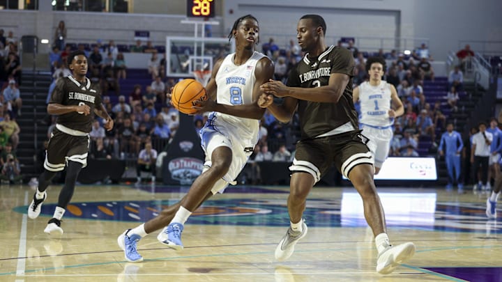 Nov 25, 2025; Fort Myers, Florida, USA; North Carolina Tar Heels forward Caleb Wilson (8) drives to the basket past St. Bonaventure Bonnies forward Daniel Egbuniwe (3) in the first half  at Suncoast Credit Union Arena. Mandatory Credit: Nathan Ray Seebeck-Imagn Images