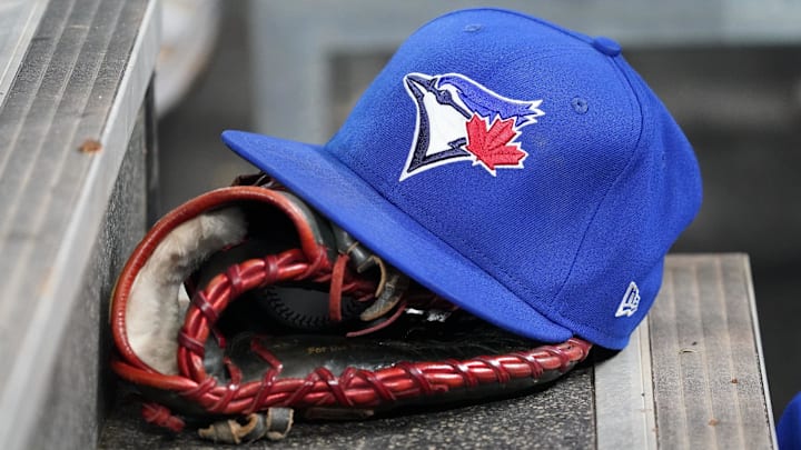 Apr 16, 2025; Toronto, Ontario, CAN; A Toronto Blue Jays hat and glove in the dugout during a game against the Atlanta Braves at Rogers Centre.
