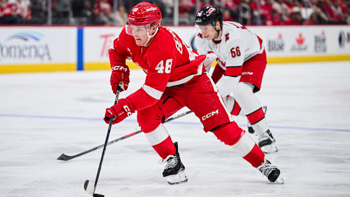 Apr 4, 2025; Detroit, Michigan, USA; Detroit Red Wings right wing Jonatan Berggren (48) brings the puck up ice during the game against the Carolina Hurricanes at Little Caesars Arena. Mandatory Credit: Tim Fuller-Imagn Images