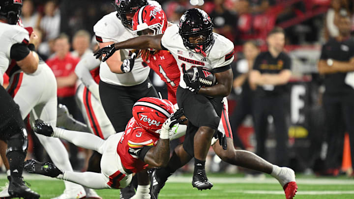 Northern Illinois Huskies running back Chavon Wright (10) breaks free from the tackle of Maryland Terrapins linebacker Trey Reddick (3) for a first down in the first half at SECU Stadium.