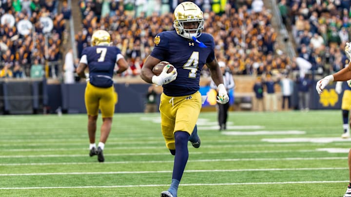Nov 22, 2025; South Bend, Indiana, USA; Notre Dame Fighting Irish running back Jeremiyah Love (4) breaks loose for a touchdown run against the Syracuse Orange during the first half at Notre Dame Stadium. Mandatory Credit: Michael Caterina-Imagn Images Nov 22, 2025; South Bend, Indiana, USA; Notre Dame Fighting Irish running back Jeremiyah Love (4) breaks loose for a touchdown run against the Syracuse Orange during the first half at Notre Dame Stadium. Mandatory Credit: Michael Caterina-Imagn Images