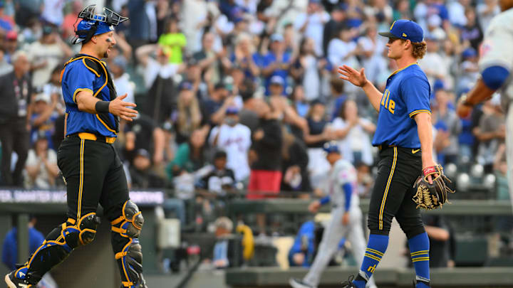 Seattle Mariners catcher Cal Raleigh (left) and reliever Troy Taylor celebrate after a win against the New York Mets on Aug. 11 at T-Mobile Park.