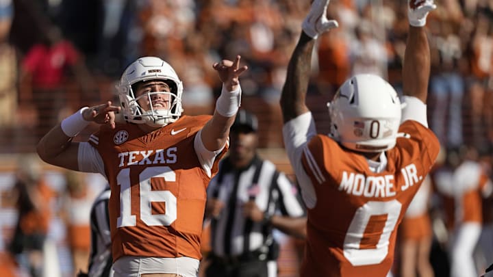 Texas Longhorns quarterback Arch Manning reacts after throwing a touchdown pass in the first half against the Arkansas Razorbacks at Darrell K Royal-Texas Memorial Stadium.