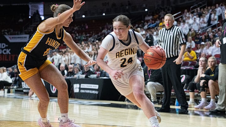 Iowa City Regina's Addie McLaughlin drives to the basket against Hinton's Addy Pigott during the IGHSAU state basketball tournament at Wells Fargo Arena on Friday, March 7, 2025, in Des Moines.