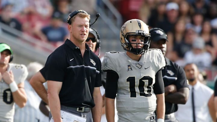 Nov 26, 2016; Tampa, FL, USA; UCF Knights head coach Scott Frost and quarterback McKenzie Milton (10) talk on the sidelines against the South Florida Bulls during the second half at Raymond James Stadium. South Florida Bulls defeated the UCF Knights 48-31. Mandatory Credit: Kim Klement-Imagn Images