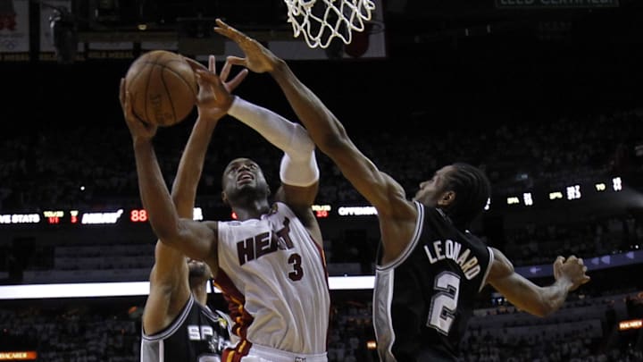 Jun 20, 2013; Miami, FL, USA; Miami Heat shooting guard Dwyane Wade (3) shoots against San Antonio Spurs small forward Kawhi Leonard (2) during the second half of game seven in the 2013 NBA Finals at American Airlines Arena. Miami Heat won 95-88 to win the NBA Championship. Mandatory Credit: Mike Segar-Reuters/Pool Photo via Imagn Images Jun 20, 2013; Miami, FL, USA; Miami Heat shooting guard Dwyane Wade (3) shoots against San Antonio Spurs small forward Kawhi Leonard (2) during the second half of game seven in the 2013 NBA Finals at American Airlines Arena. Miami Heat won 95-88 to win the NBA Championship. Mandatory Credit: Mike Segar-Reuters/Pool Photo via Imagn Images