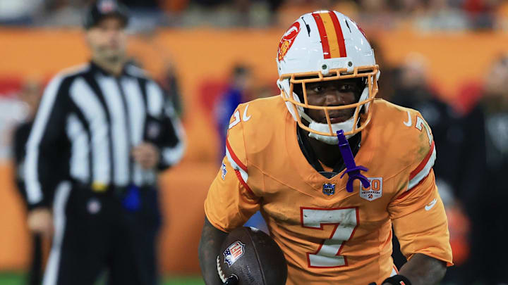 Dec 11, 2025; Tampa, Florida, USA; Tampa Bay Buccaneers running back Bucky Irving (7) runs the ball against the Atlanta Falcons during the second quarter at Raymond James Stadium. 