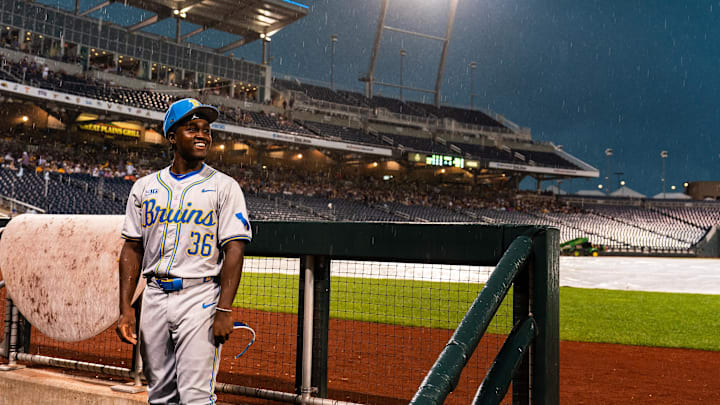 Jun 16, 2025; Omaha, Neb, USA; UCLA Bruins left fielder Dean West (36) sits in the dugout in the rain during a storm delay in the fourth inning against the LSU Tigers at Charles Schwab Field. Mandatory Credit: Dylan Widger-Imagn Images Jun 16, 2025; Omaha, Neb, USA; UCLA Bruins left fielder Dean West (36) sits in the dugout in the rain during a storm delay in the fourth inning against the LSU Tigers at Charles Schwab Field. Mandatory Credit: Dylan Widger-Imagn Images