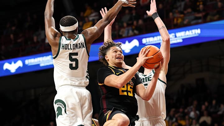 Dec 4, 2024; Minneapolis, Minnesota, USA; Minnesota Golden Gophers guard Lu'Cye Patterson (25) shoots as Michigan State Spartans guard Tre Holloman (5) and center Carson Cooper (15) defend during the first half at Williams Arena. Mandatory Credit: Matt Krohn-Imagn Images Dec 4, 2024; Minneapolis, Minnesota, USA; Minnesota Golden Gophers guard Lu'Cye Patterson (25) shoots as Michigan State Spartans guard Tre Holloman (5) and center Carson Cooper (15) defend during the first half at Williams Arena. Mandatory Credit: Matt Krohn-Imagn Images