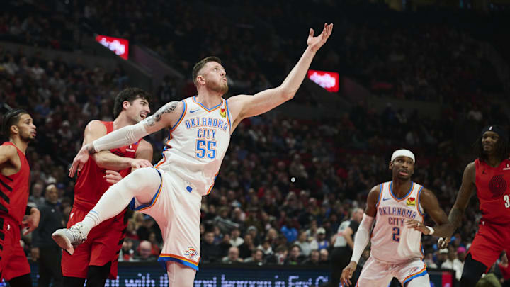 Jan 26, 2025; Portland, Oregon, USA; Oklahoma City Thunder center Isaiah Hartenstein (55) grabs a rebound shoots a jump shot during the first half against Portland Trail Blazers forward Deni Avdija (8) at Moda Center. Mandatory Credit: Troy Wayrynen-Imagn Images