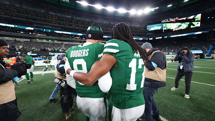 Jan 5, 2025; East Rutherford, New Jersey, USA; New York Jets quarterback Aaron Rodgers (8) and wide receiver Davante Adams (17) walk on the field after the Jets win over the Miami Dolphins at MetLife Stadium. Mandatory Credit: Ed Mulholland-Imagn Images