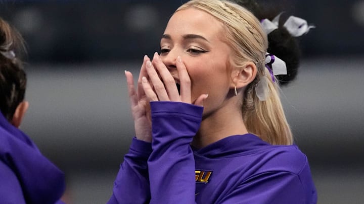 LSU gymnast Livvy Dunne stretches with teammates before Session 2 of the SEC Gymnastics Tournament at Legacy Arena in Birmingham, Alabama.