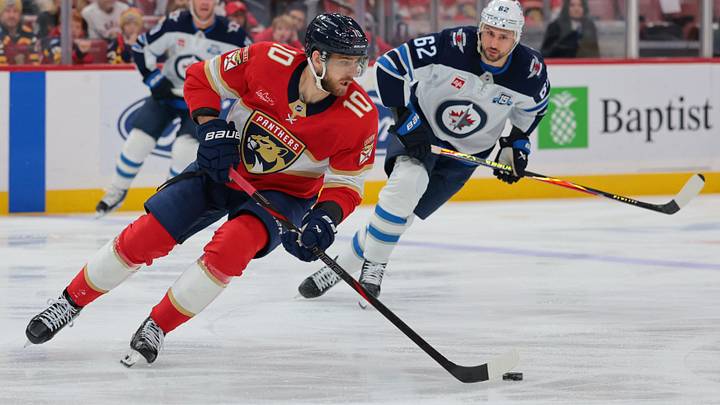 Jan 31, 2026; Sunrise, Florida, USA; Florida Panthers left wing A.J. Greer (10) moves the puck against the Winnipeg Jets during the first period at Amerant Bank Arena. Mandatory Credit: Sam Navarro-Imagn Images